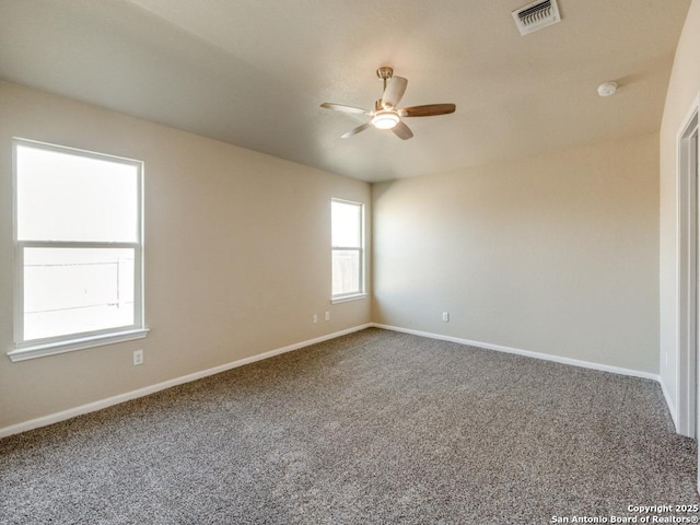 unfurnished room featuring a ceiling fan, baseboards, visible vents, and carpet