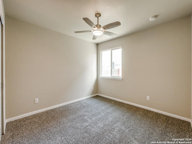 empty room featuring baseboards, carpet flooring, and ceiling fan