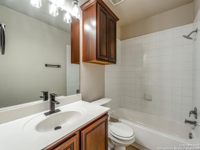 bathroom with toilet, shower / bathing tub combination, and vanity