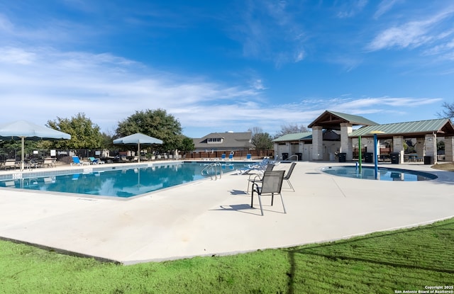 pool with fence and a patio area
