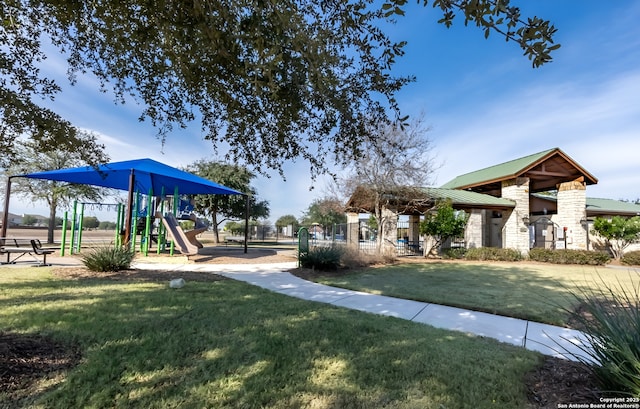 view of community featuring a lawn and playground community
