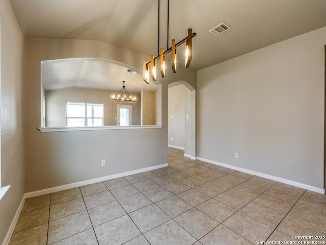 tiled spare room with a notable chandelier, arched walkways, baseboards, vaulted ceiling, and visible vents