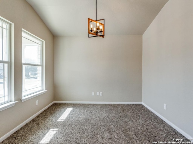 carpeted spare room with baseboards and a notable chandelier