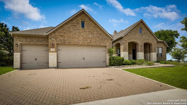 730 San Anza, San Antonio, TX 78260 - view of front of home featuring brick siding, an attached garage, a front lawn, and decorative driveway