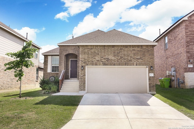 view of front of property with roof with shingles, a front yard, driveway, and brick siding