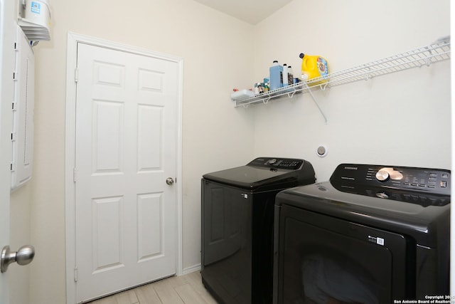laundry room featuring laundry area, light wood-style flooring, and independent washer and dryer