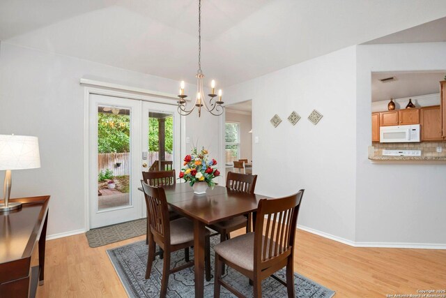 9503 Kirk Pond, San Antonio, TX 78240 - dining room featuring a chandelier, light wood-style flooring, and baseboards