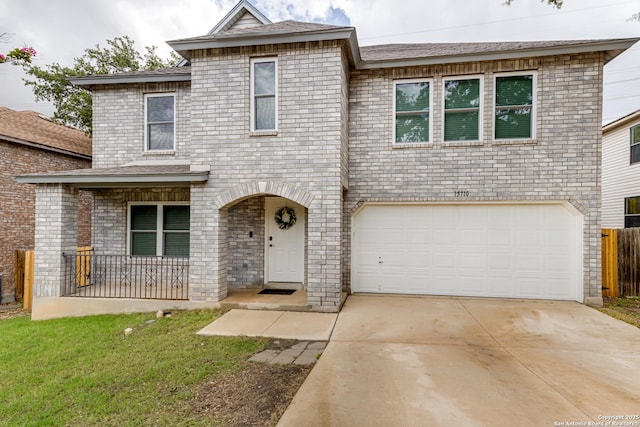 traditional-style house with covered porch, a garage, brick siding, fence, and concrete driveway