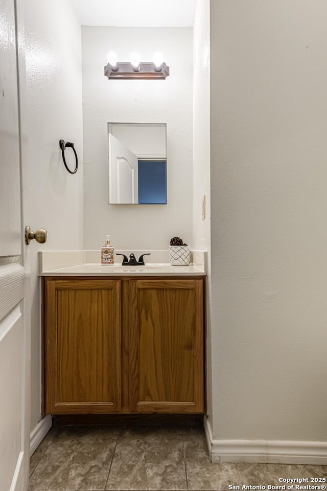 bathroom with vanity and baseboards
