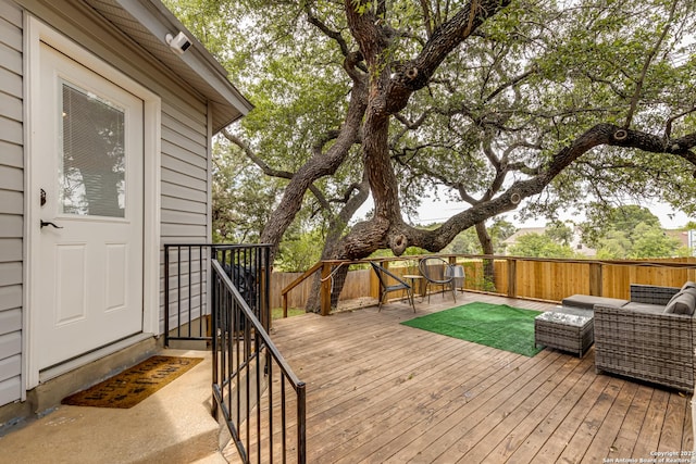 deck featuring fence and an outdoor living space