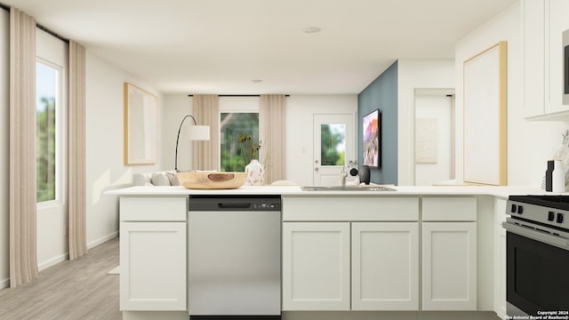 kitchen featuring a sink, light countertops, baseboards, light wood-style floors, and stainless steel appliances