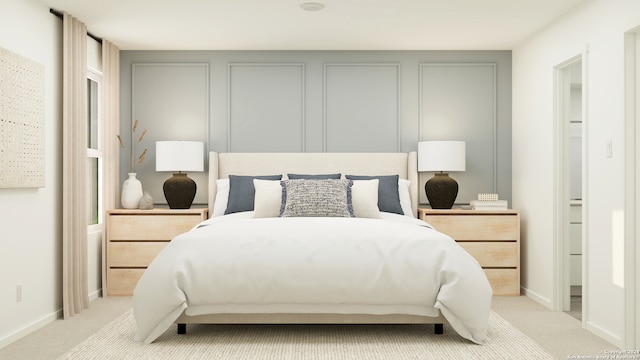bedroom featuring baseboards and light carpet