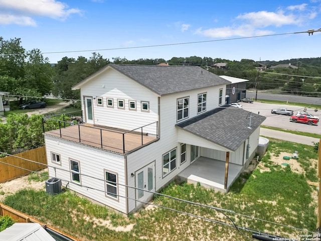back of property featuring roof with shingles, fence, french doors, a patio area, and central air condition unit