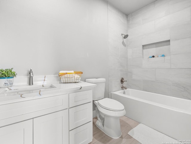 full bathroom featuring vanity, bathtub / shower combination, toilet, and wood finished floors
