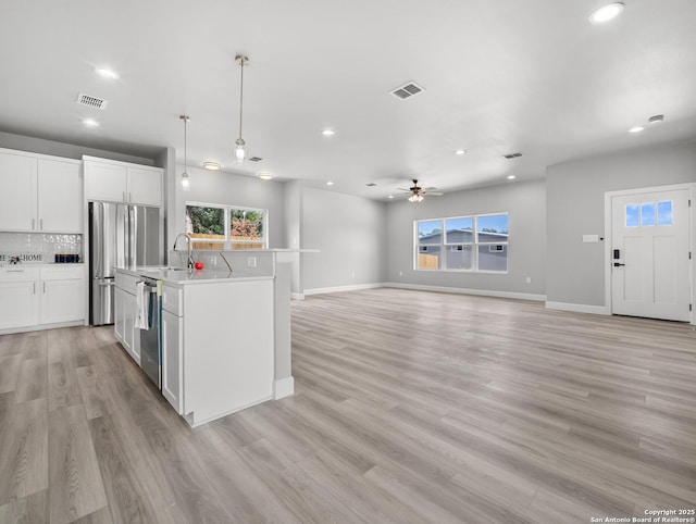 kitchen with appliances with stainless steel finishes, recessed lighting, and visible vents