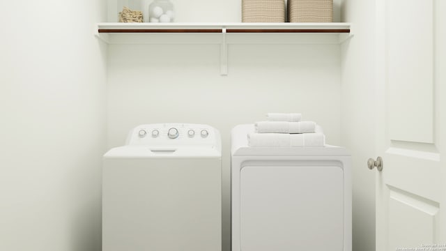 laundry area with laundry area and washer and clothes dryer