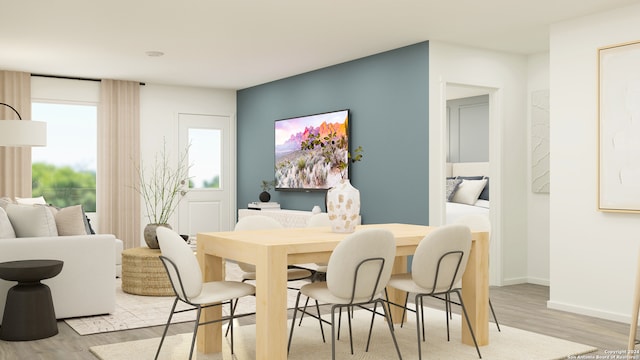 dining area featuring baseboards and light wood finished floors