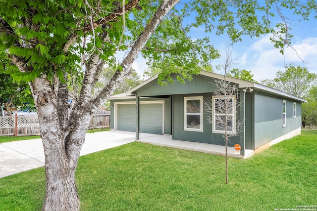 2430 Bermuda, San Antonio, TX 78222 - view of front of property featuring a garage, fence, driveway, and a front yard