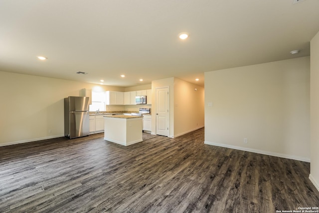 2430 Bermuda, San Antonio, TX 78222 - kitchen with dark wood-type flooring, open floor plan, and stainless steel appliances
