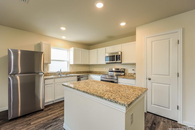 2430 Bermuda, San Antonio, TX 78222 - kitchen featuring a center island, dark wood-type flooring, white cabinets, a sink, and stainless steel appliances