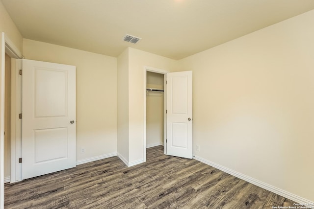 2430 Bermuda, San Antonio, TX 78222 - unfurnished bedroom with a closet, baseboards, visible vents, and dark wood-type flooring