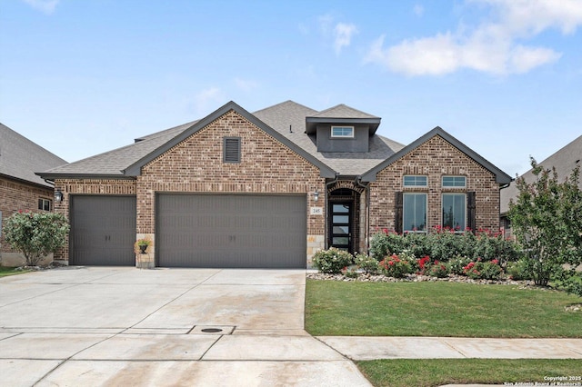 craftsman inspired home with roof with shingles, a front lawn, brick siding, a garage, and driveway
