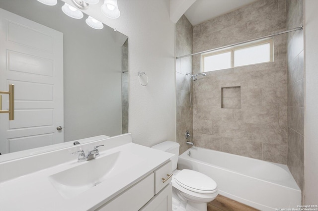 bathroom with vanity, bathing tub / shower combination, and toilet