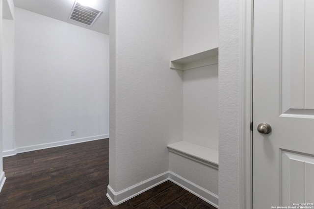 mudroom with baseboards, visible vents, and dark wood finished floors