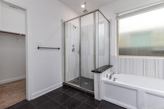 full bath with tile patterned floors, baseboards, visible vents, a bath, and a stall shower