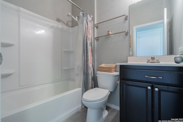 full bath featuring toilet, a textured wall, shower / bath combo with shower curtain, and vanity