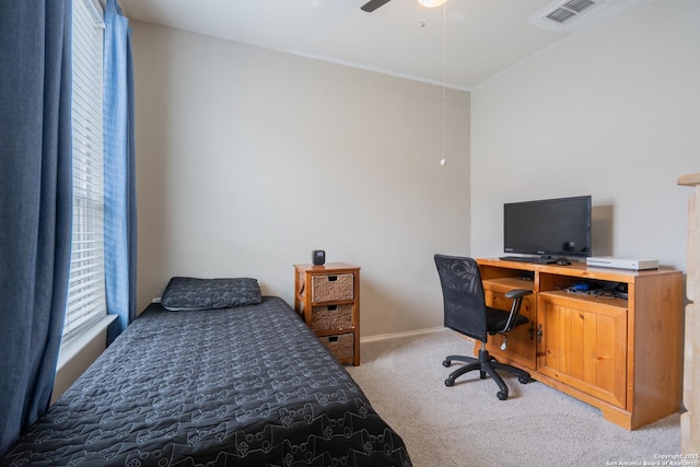 bedroom with carpet floors, crown molding, visible vents, baseboards, and ceiling fan