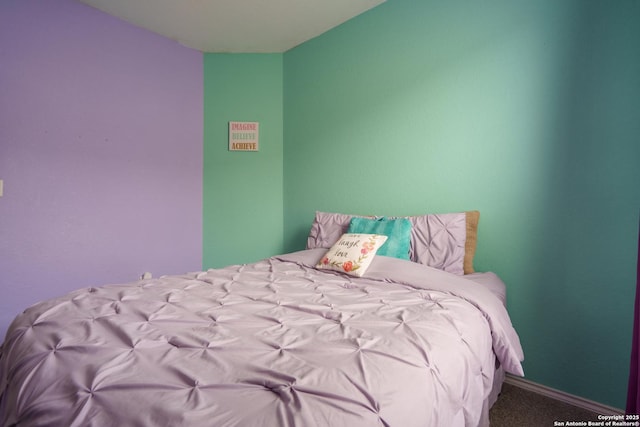 carpeted bedroom with baseboards