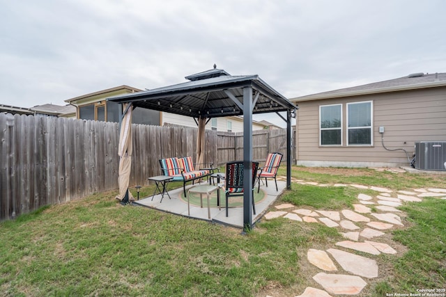 view of yard featuring a fenced backyard, a gazebo, a patio area, and central AC