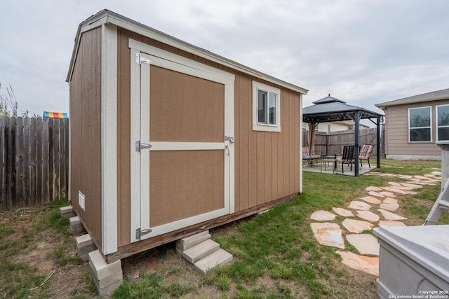 view of shed featuring a fenced backyard and a gazebo