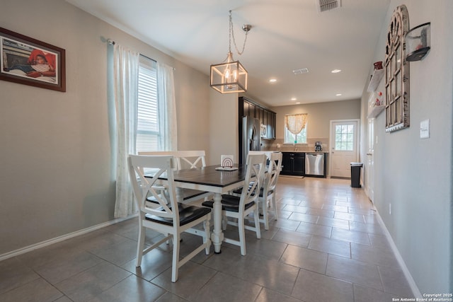 dining room featuring baseboards, light tile patterned floors, a chandelier, and visible vents