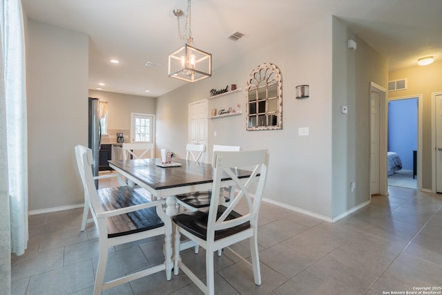 dining space featuring visible vents, baseboards, light tile patterned flooring, and a notable chandelier