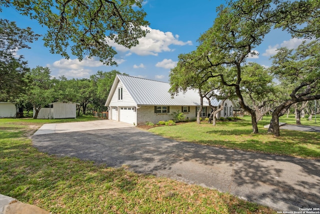 7904 N Verde, San Antonio, TX 78240 - view of front facade featuring brick siding, concrete driveway, metal roof, a storage shed, and a front lawn