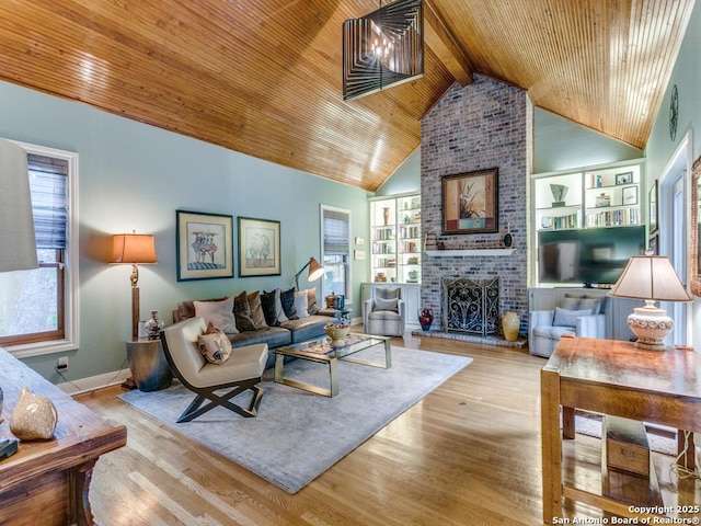 living room featuring lofted ceiling with beams, wood ceiling, wood finished floors, and a fireplace