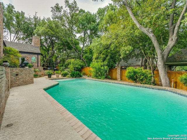 view of swimming pool featuring a fenced in pool and a fenced backyard