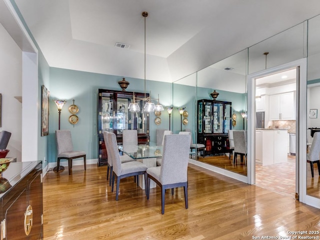dining space with visible vents and light wood-style floors