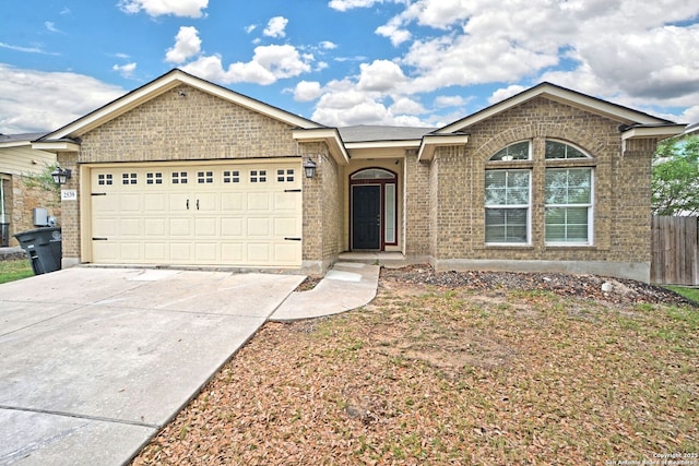 single story home featuring a garage, fence, driveway, and brick siding