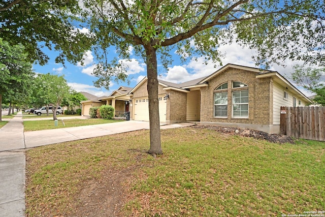 single story home featuring fence, a front lawn, brick siding, a garage, and concrete driveway