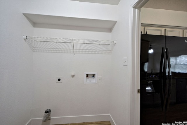 laundry area featuring laundry area, baseboards, gas dryer hookup, washer hookup, and hookup for an electric dryer