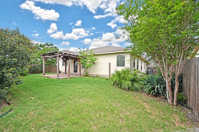 back of house with a fenced backyard, a patio, a yard, and a pergola