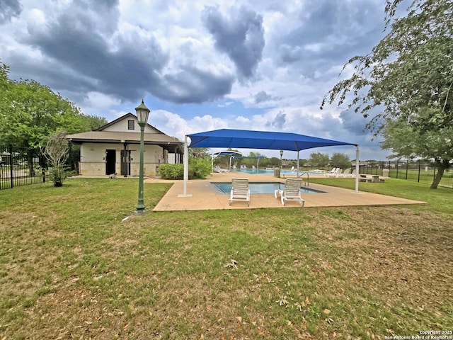 view of home's community with a lawn, a swimming pool, a patio area, and fence