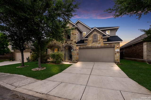 12422 Caprock Crk, San Antonio, TX 78254 - traditional-style home with a garage, stone siding, board and batten siding, concrete driveway, and a yard