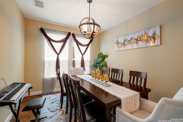 12422 Caprock Crk, San Antonio, TX 78254 - dining area with visible vents, an inviting chandelier, a textured wall, wood finished floors, and baseboards