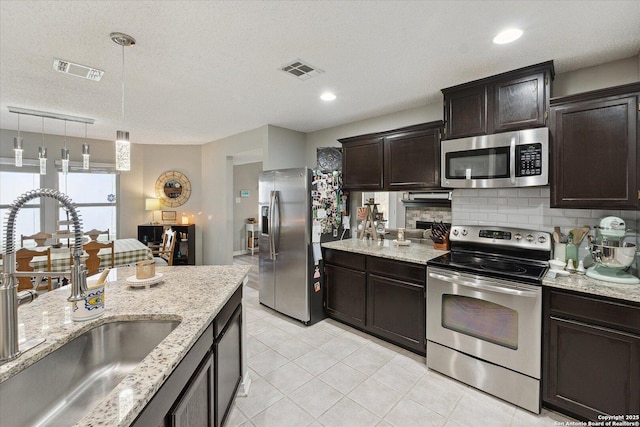 6927 Country Rose, San Antonio, TX 78240 - kitchen with appliances with stainless steel finishes, a sink, visible vents, and tasteful backsplash