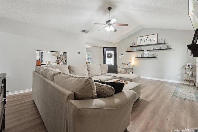 6927 Country Rose, San Antonio, TX 78240 - living area with ceiling fan, vaulted ceiling, wood finished floors, and visible vents