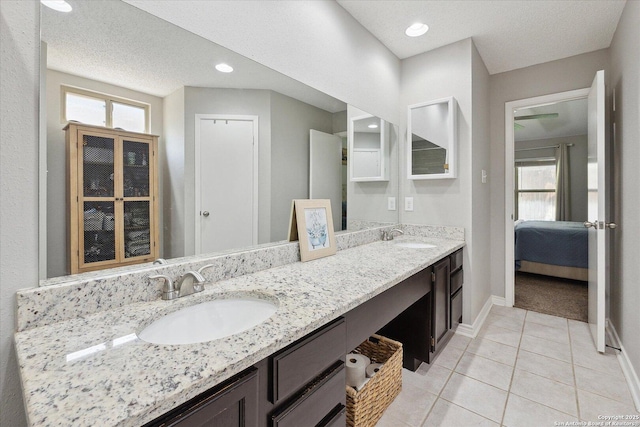 6927 Country Rose, San Antonio, TX 78240 - ensuite bathroom with a sink, baseboards, tile patterned floors, and double vanity